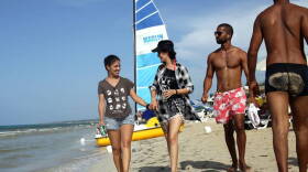 A Cuban lesbian couple stroll a beach near Havana.
