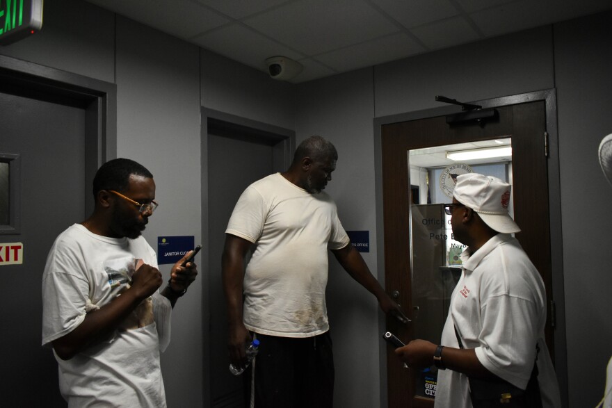 Vernardo Malone, Tyree Bonds, and Rev. Sylvester Williams entering the South Bend mayor's office. (Annacaroline Caruso/WVPE News)