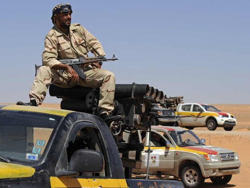A Libyan National Transitional Council fighter keeps watch from atop his rocket launcher during a patrol mission near Wadi Bei, near the western city of Misrata, on Sunday.