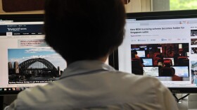A person browses through media websites on a computer in Singapore.  (Roslan Rahman/AFP/Getty Images)