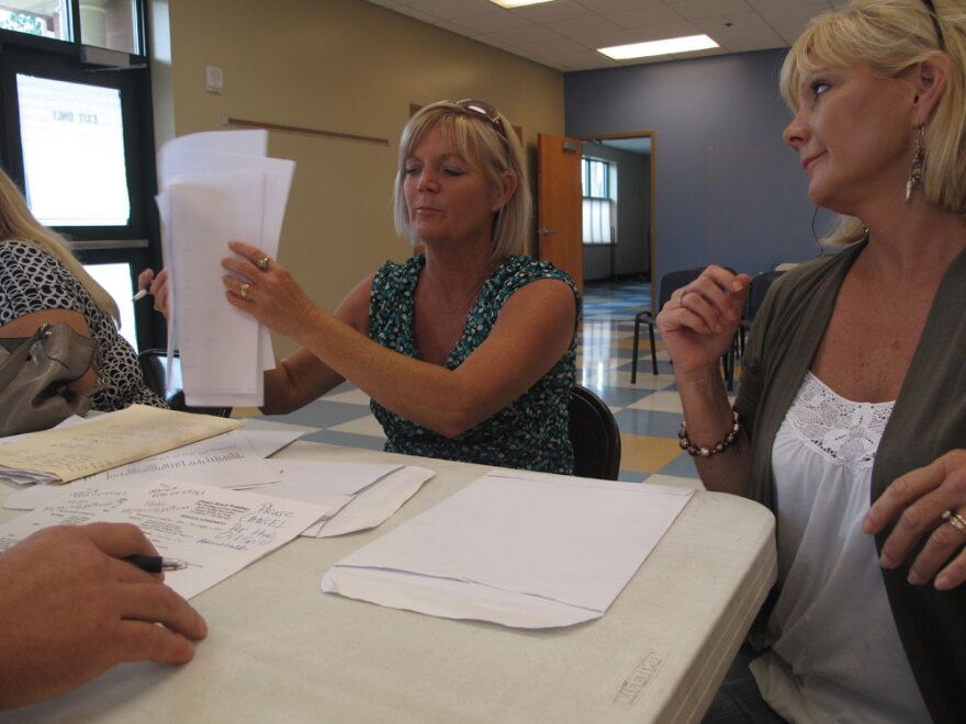 Twin sisters Sheila Newman (left) and Sheryl Lindsay of Orange Beach, Ala., make their case to a BP claims adjuster. The wedding planners have been trying since June to get BP to pay for lost income from the oil spill.