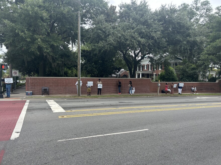 Protestors on Market Street across the UNCW chancellor’s house.