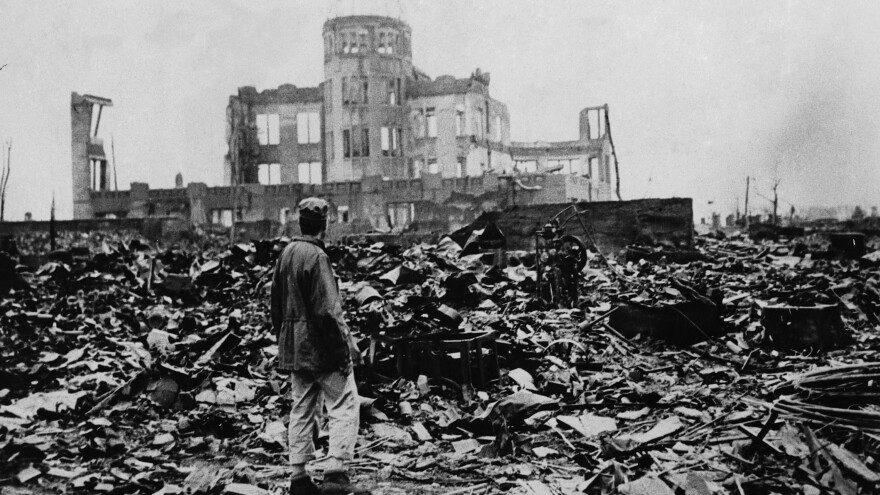 One month after the atomic bomb was dropped on Hiroshima, a man stands amid ruins left by the explosion. The structure seen standing became the Hiroshima Peace Memorial, which President Obama visited Friday.