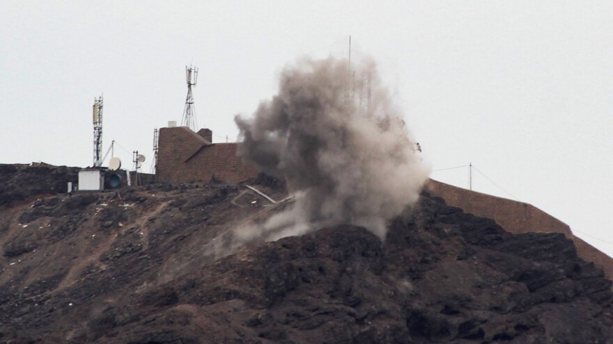 Smoke billows from a hilltop during clashes Sunday between southern separatists and forces loyal to the Saudi-backed Yemeni president in Aden.