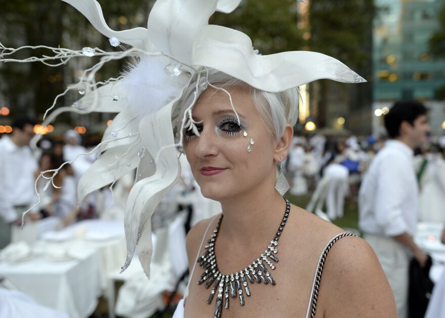 Many guests see Diner en Blanc as an occasion to unleash their fashion whimsy. The event is always held outdoors, always at a landmark location revealed at the last-minute. Here, a guest at the Bryant Park event last week.