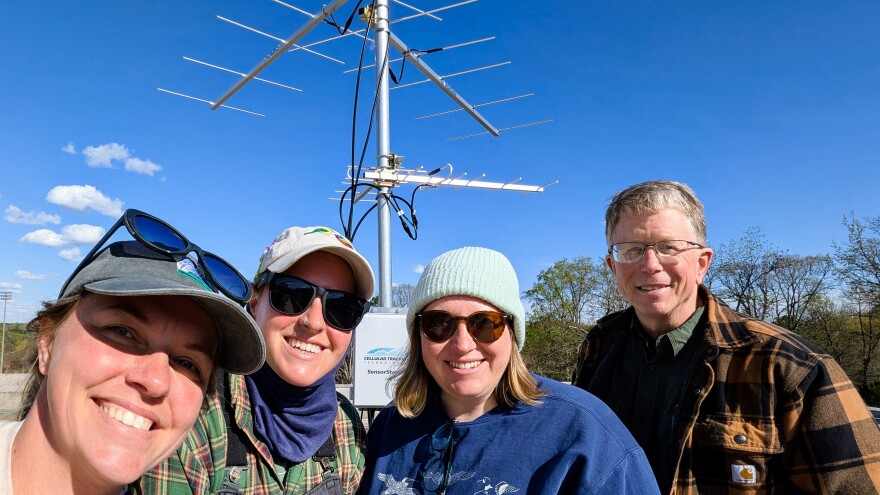 Marae West and Evan Buckland of Cape Fear Bird Observatory; Nicole Baran, a biology professor at Davidson College; and Joe Poston, the Biology Department chair at Catawba College stand in front of Davidson's new bird-tracking tower.