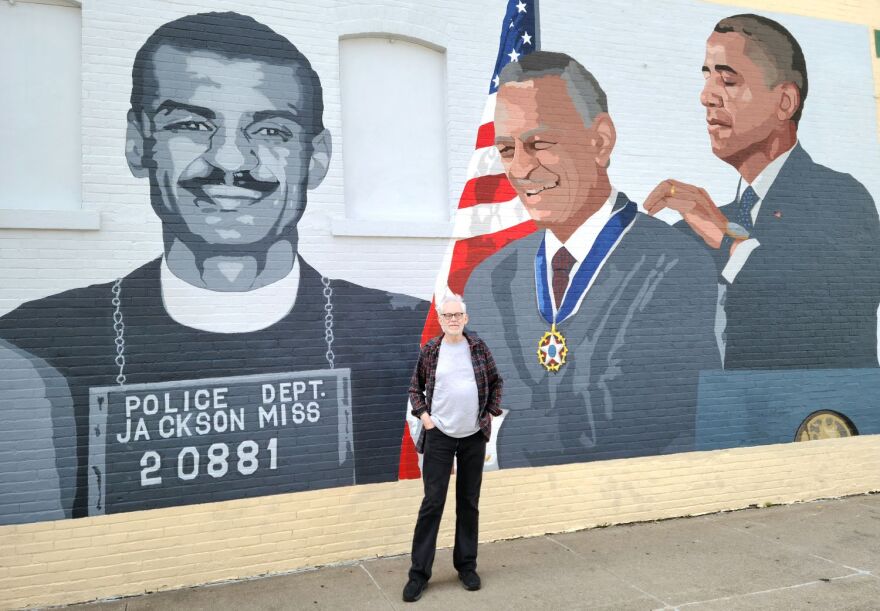 Michael Mahoney alongside the mural he created of the Rev. Dr. C.T. Vivian in downtown Macomb.