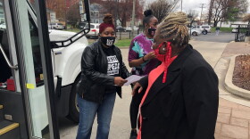 Harriett Rankin, a member of Black Lives Matter Louisville, helps residents board a van to get their second dose of the COVID-19 vaccine.