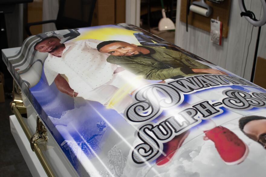 A Touch of Jai offers full customization of a casket, including top or full wraps, handle recoloring and interior graphics. "I love that so many families come to us to commemorate their life, not just their passing but their life," Larry Fulton said. (Jackson Castellano/WUFT News)