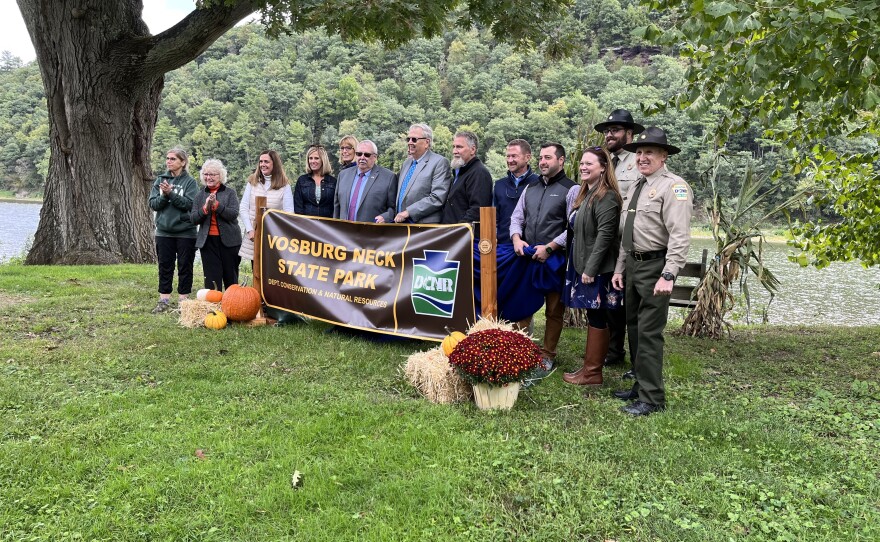 Local and state representatives unveil a new sign at Vosburg Neck State Park.