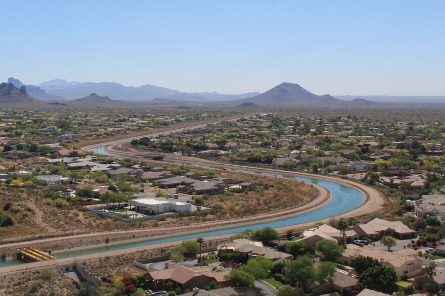 The Central Arizona Project canal winds through a neighborhood in the Phoenix area on March 26, 2026. Dire snow conditions and stalled negotiations may lead to mandatory cutbacks to the Colorado River Water carried by the canal.