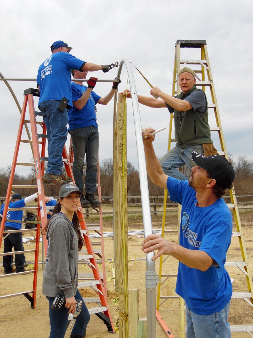 Arcadia volunteers, along with vets from the group <em>The Mission Continues</em> built a 60-foot hoop-house in one day, barn-raising style.