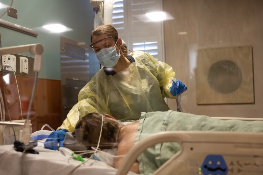 A hospital worker tends to a COVID patient at St. Luke's Hospital in Dec. 2020. Officials say COVID cases could snowball in the coming days, following a busy holiday travel season and the rise of the highly-contagious omicron variant.