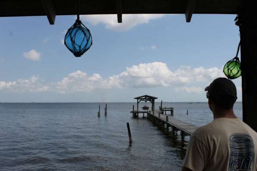 Brandon Burdine looks out across the Indian River Lagoon from the shore of his parents' house in Titusville. Photo: Matthew Peddie, WMFE