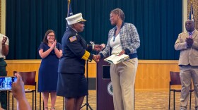July 18, 2025 — Hamden, Ct. — Named as Hamden’s new fire chief, Shelly Carter is congratulated by first Mayor Lauren Garrett (left), Town Clerk Karimah Mickens and Public Safety Chair Adrian Webber (right). (Macy Hanzlik-Barend/Connecticut Public)
