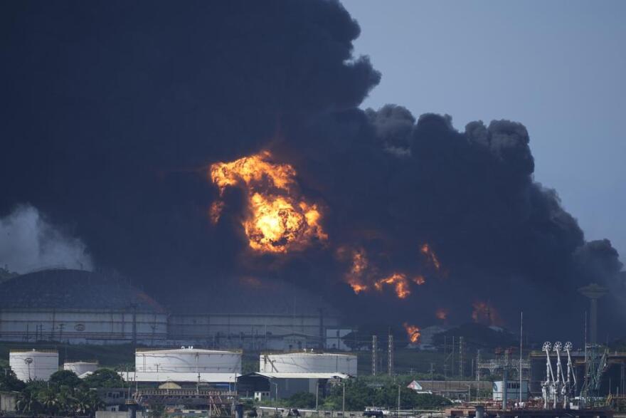 Flames and smoke rise from the Matanzas Supertanker Base, as firefighters and specialists work to quell the blaze which began during a thunderstorm the night before, in Matazanas, Cuba, Saturday, Aug. 6, 2022. Cuban authorities say lightning struck a crude oil storage tank at the base, causing a fire that led to four explosions which injured dozens.