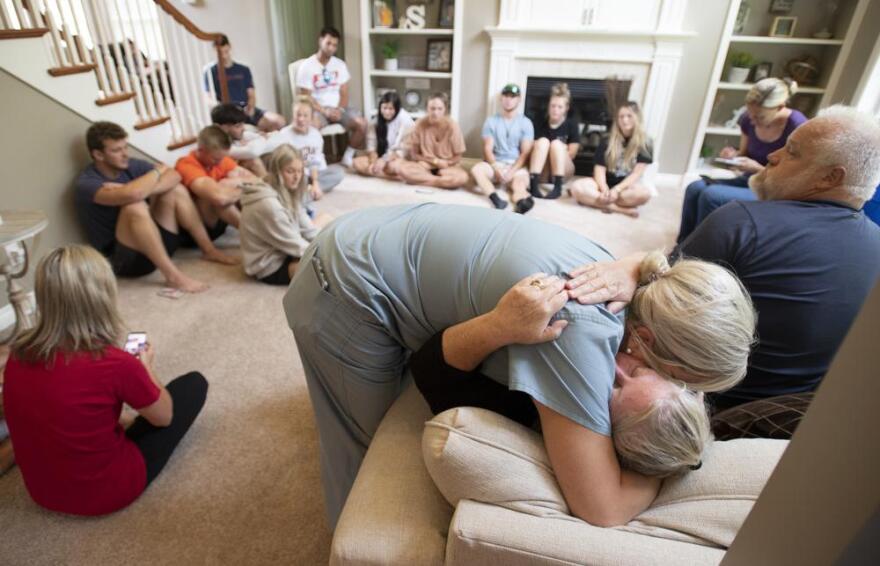 Amy Satterthwaite, the mother of Richie Mays Jr., gets a hug as family and friends gather to remember Kole Sova, Dawson Brown and Mays at the home of Jerry and Meeka Sova near Jackson, Mich., Sunday, July 18, 2021. The three young men, all recent Michigan Center High School graduates, were found dead likely from carbon monoxide exposure in a camper on July 17 at the Faster Horses Festival at Michigan International Speedway.