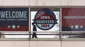 A man walks past a sign that reads "Iowa Caucuses 2024" in downtown Des Moines, Iowa, Saturday, Jan. 13, 2024. (Andrew Harnik/AP)