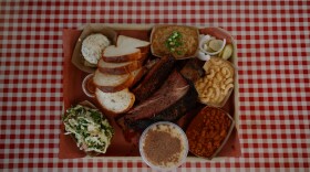 A tray at Goldee’s Barbecue features smoked brisket, ribs, sausage, turkey, house-made bread and a selection of sides.