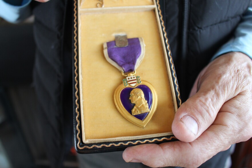 Grand Traverse Band member Hank Bailey holds a Purple Heart awarded to a Michigan solider during World War II. He plans to reunite the medal with the recipient's family after it was purchased in an Ypsilanti antique store. (Photo: Ellie Katz/IPR News)