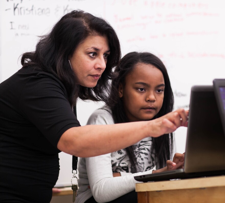 Incubator founder and sixth-grade teacher Sujata Bhatt assists student Elise Mayfield with a Minecraft assignment. Much of the classroom learning is done independently or as a group, with the teacher stepping in as needed.