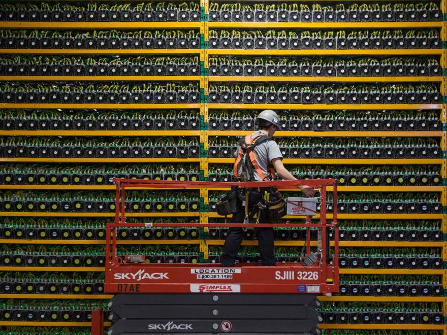 A technician inspects the backside of bitcoin mining at Bitfarms in Saint Hyacinthe, Quebec, Canada on March 19, 2018. There's also considerable debate about how the halving will impact the amount of energy involved in bitcoin mining.