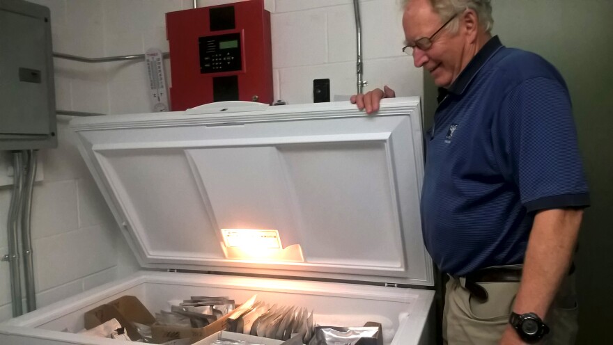 New England Wildflower Society's Bill Brumback, opening the freezer that acts as the "seed vault," in Framingham, Mass.