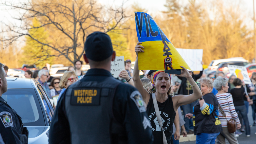 Protesters took the opportunity to voice their concerns when the doors opened as people walk out of the town hall.