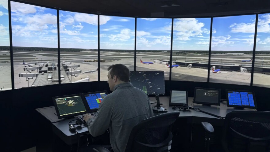 UMass research assistant and engineering professor Cole Fitzpatrick demonstrates an air traffic control simulator at the university's transportation center in Chicopee.