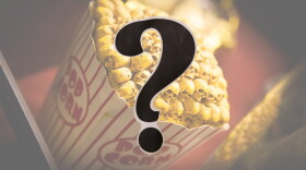 A bucket of movie popcorn, but the popcorn is skulls; a question mark in the foreground