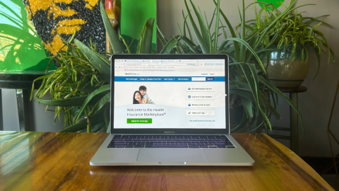 A photo of a laptop that has the healthcare.gov homepage open.