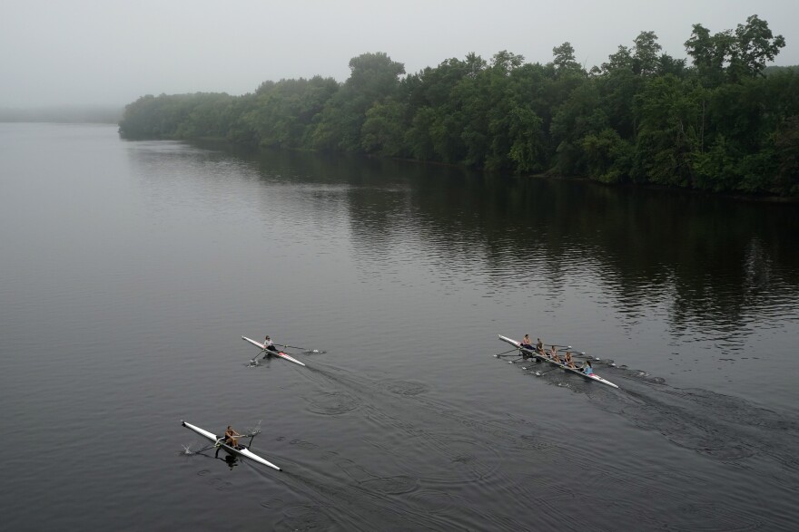 Members of the Maine Coast Juniors Rowing Club including single scullers Emily Drappeau, of Dresden, Maine, left, and Noa Sweden, center, of Phippsburg, Maine, set off on a 12-kilometer training workout on the Androscoggin River, Wednesday, July 14, 2021, in Brunswick, Maine.