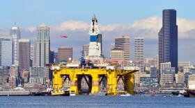 Foss Maritime tugs pull the Polar Pioneer past downtown Seattle on the way to Terminal 5 on Thursday, May 14, 2015.