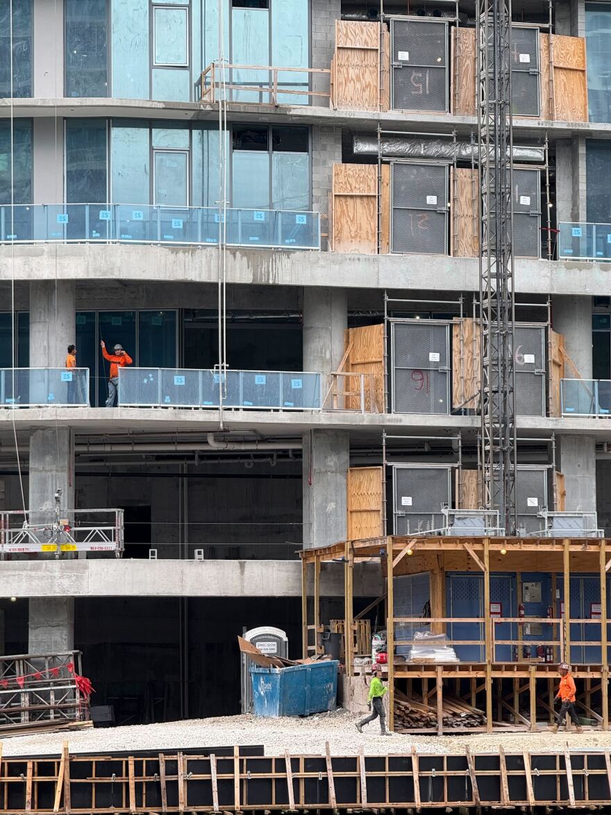 Construction crews work on a new residential building along the Miami River in Brickell in Sept. 2025.
