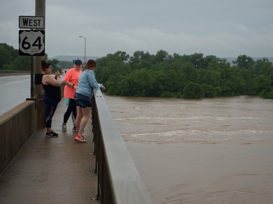 A group of friends look at the record-high Arkansas River in Fort Smith, Ark. "It's part of history now," says Savanna Bowling. "We had to come see it."
