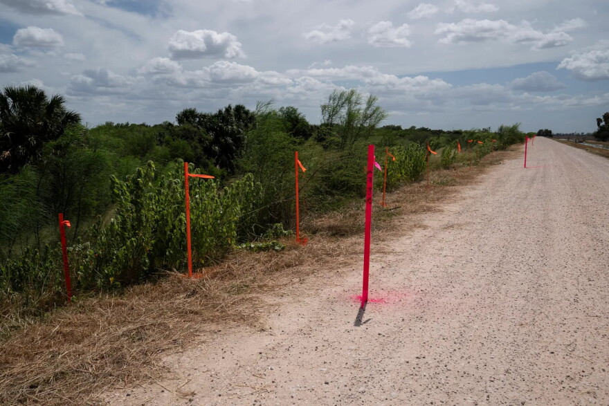 Survey stakes mark the proposed location of the border wall at the Santa Ana National Wildlife Refuge near Alamo on July 8, 2026.