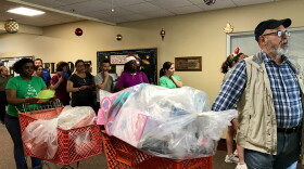 Hundreds of volunteers help Broward County parents pick up and load Christmas gifts for their children in time for Christmas.