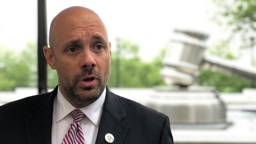 Rep. Jeff Crossman (D-Parma), outside of the Ohio Judicial Center, discusses filing criminal complaints against Republican redistricting commissioners. [Andy Chow /  Statehouse News Bureau]