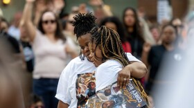 Corey Ruiz’s daughter, right, is embraced as she attends a vigil in memory of her father Thursday, July 23, 2026, in Madison, Wis. Ruiz was shot and killed by Madison police Wednesday afternoon.