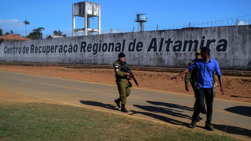 A police officer patrols the surroundings of the Altamira Regional Recovery Centre after at least 52 inmates were killed in a prison riot, in the Brazilian northern city of Altamira, Pará state, on Monday.