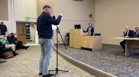 Jay Batson of Bourne speaks at meeting on the Cape Cod bridges replacement project held at Massachusetts Maritime Academy, Dec. 16, 2025. Listening at the podium is Luisa Paiewonsky, executive director of the Megaprojects Delivery Office at the Massachusetts Department of Transportation.