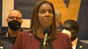 New York Attorney General Tish James, wearing a black and red checked suit