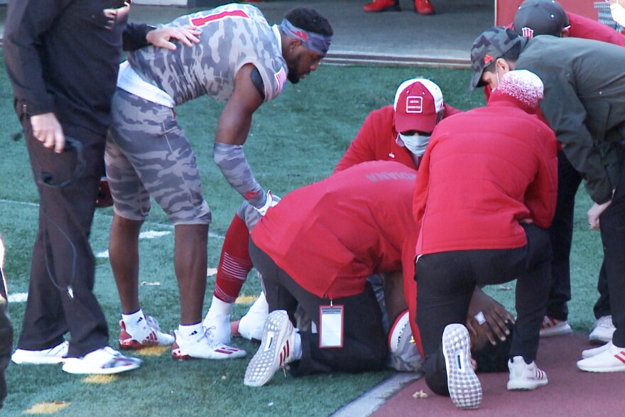 Indiana wide receiver Whop Philyor checks on quarterback Michael Penix as he is attended to by medical personnel after being injured during Saturday's game against Maryland.