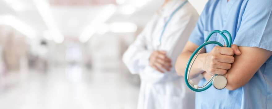 Surgeon and anesthetist doctor ER team with medical clinic room background for emergency nursing care professional teamwork and patient trust in hospital's hospitality concept 