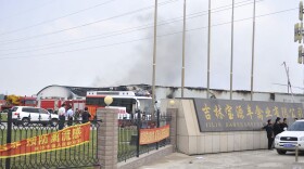 In this photo released by China's Xinhua News Agency, smoke rises from a poultry farm owned by Jilin Baoyuanfeng Poultry Company in Jilin province on Monday.