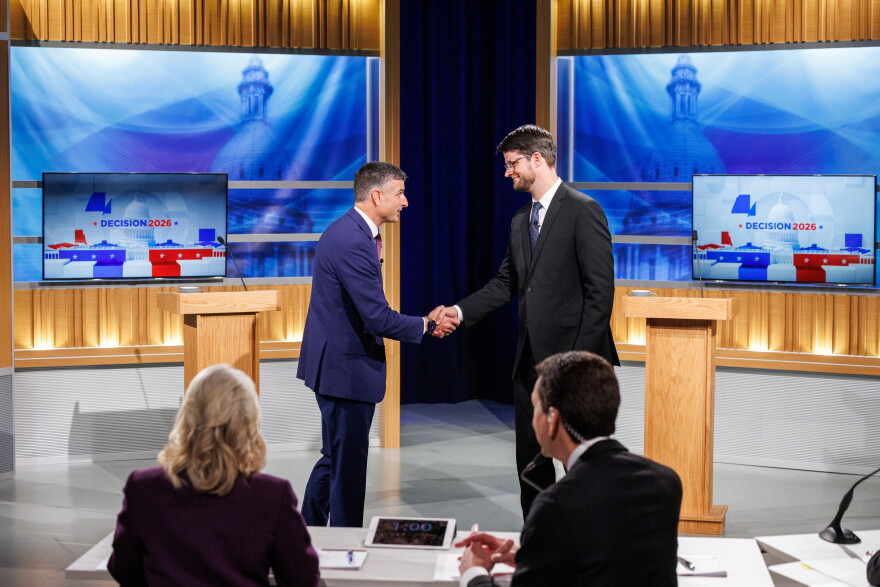 U.S. Rep. Tom Barrett, R-Charlotte, left, and Democratic nominee for U.S. House William Lawrence, right, shake hands.