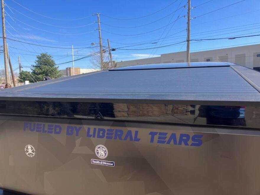 A Tesla with a sticker reading, "Fueled by liberal tears," is seen on Saturday, March 22, 2025. This Tesla belongs to Steven Vining, a Musk supporter who offered people $50 to counterprotest. However, no one reported being paid. Vining was out of town on the day of the protest and his long-time friend Kyla Keith said she drove it as a show of support.