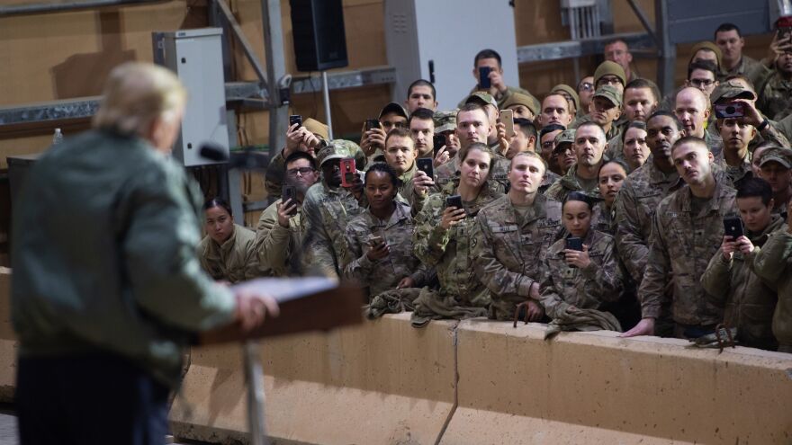 President Trump speaks to members of the U.S. military during an unannounced trip to Al Asad Air Base in Iraq on Dec. 26.