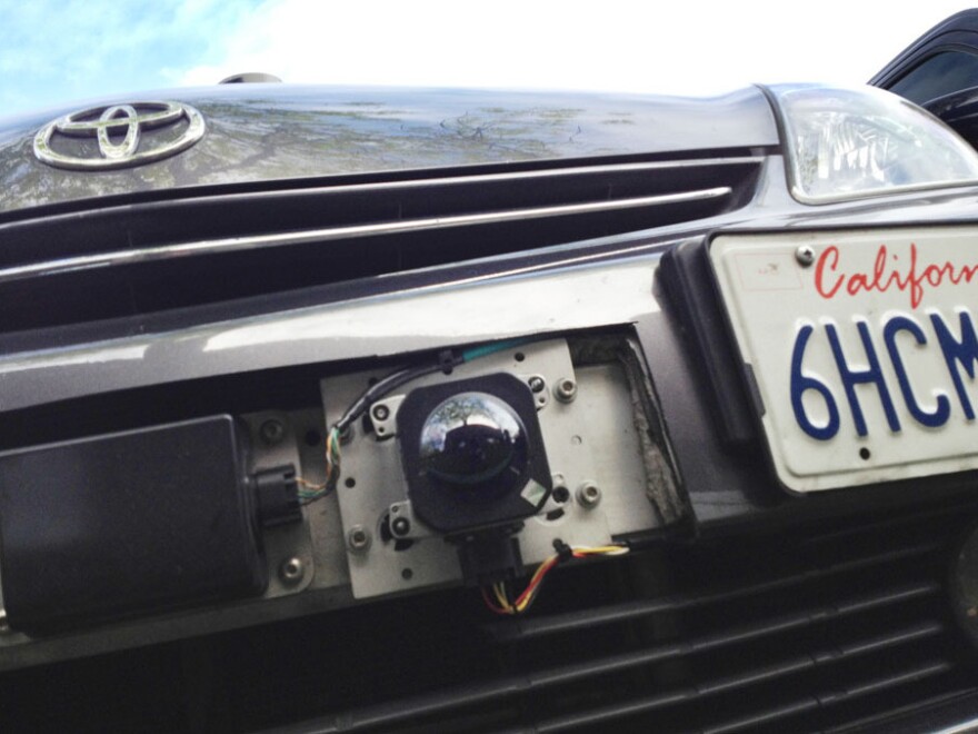 A car camera attached to the front bumper of Google's driverless car.