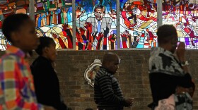Congregants pray in front of a stained-glass window depicting South African statesman Nelson Mandela during Easter services at Regina Mundi Catholic Church in the Soweto of Johannesburg, South Africa, March 3. The church held prayers for Mandela, 94, who was in the hospital at the time.